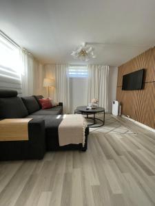 a bedroom with a bed and a television in it at Strömspärlan - Nordic Stay Strömstad in Strömstad