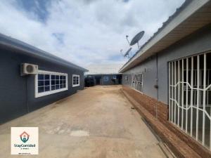 an empty building with a fence in front of it at StayComidad in Dawhwenya