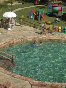 a couple of people in a pool of water at Rio Quente Thermas Paradise in Rio Quente