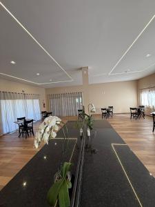 a large room with tables and chairs and a dance floor at Pousada Maritaca in Bonito +76 photos