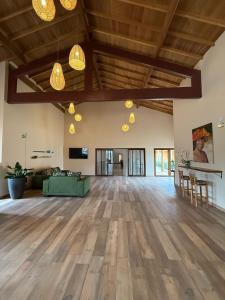 an open living room with wooden floors and wooden ceilings at Pousada Maritaca in Bonito