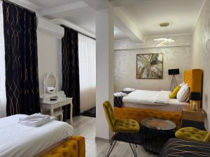 a hotel room with two beds and a chair at Golden Hill Palace in Novi Pazar +290 photos