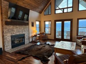 a living room with a fireplace and a couch at Cody WY Yellowstone Luxury Mountain Retreat 