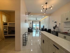 a kitchen and living room with a counter and a room at Langkawi Simfoni Platinum Suite in Kuah