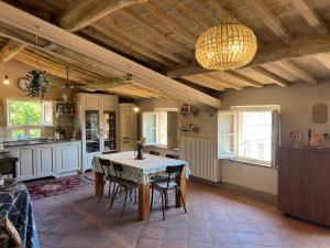a kitchen with a table and chairs and a chandelier at da Francesco rooms in Lucca