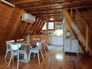 a dining room with a wooden table and chairs at Izdebno 68 in Izdebno