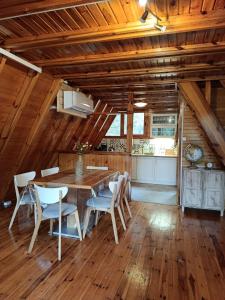 a kitchen and dining room with a table and chairs at Izdebno 68 in Izdebno +12 photos