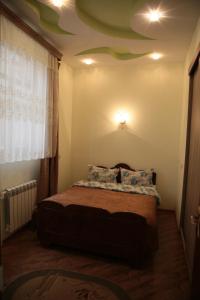 a bedroom with a bed with a green ceiling at Jermuk Apartment in the Center in Jermuk