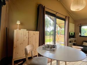 a room with a white table and a table and chairs at Veluwse boerderij beleving - Hoeve Meijer in Harskamp