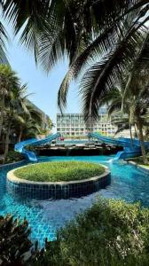 a water slide in a resort with palm trees at Laguna Beach Resort 2 in Ban Chek