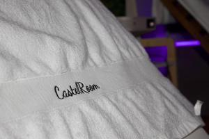 a close up of a white blanket with the word casket nation on it at Castel Room in Pont-du-Château +14 photos