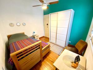 a small bedroom with a bed and a mirror at Habitación privada, solo Damas "Alma de mujer" in Buenos Aires