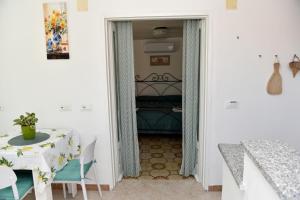 a dining room with a table and a bed at Casetta Achille, Ischia-Napoli in Ischia