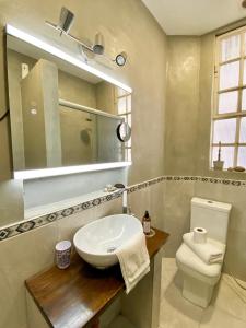 a bathroom with a toilet and a sink and a mirror at Habitación privada, solo Damas "Alma de mujer" in Buenos Aires