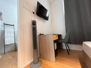 a room with a wall mounted radiator and a tv at Terra Buona Rooms in Traona