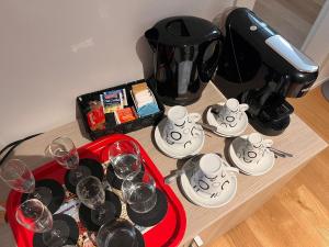 a table with glasses of wine and a coffee maker at Terra Buona Rooms in Traona