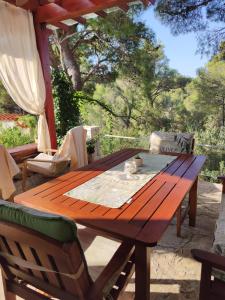 a wooden table and chairs on a patio at Vacation house Milka in Milna