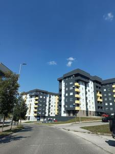 an empty street in front of some apartment buildings at Apartman Samsara in Sarajevo