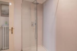 a shower with a glass door in a bathroom at Victoria Palace in Salò +21 photos