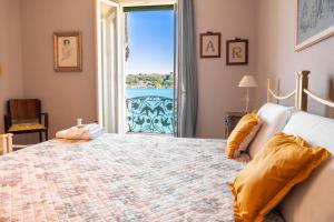 a bedroom with a large bed with a large window at Victoria Palace in Salò