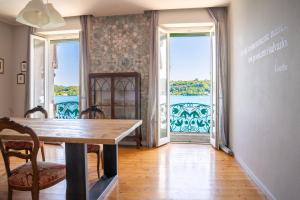 a dining room with a table and views of the water at Victoria Palace in Salò