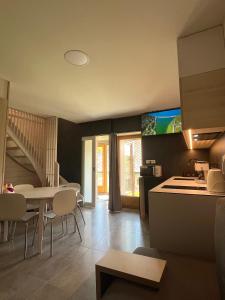 a kitchen and living room with a table and chairs at Hacienda Dedinky B in Dedinky