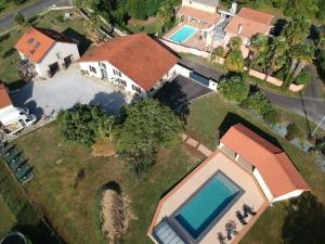 an aerial view of a house with a swimming pool at Domaine de Grisere in Tilh