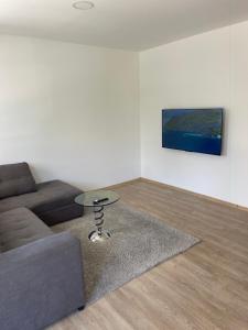 a living room with a couch and a table at Elbas Apartman in Široki Brijeg