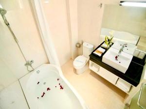 a bathroom with a tub and a toilet and a sink at Spring House Park View - Central City in Ho Chi Minh City
