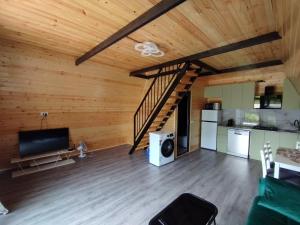 a living room with wooden walls and a wooden ceiling at Cottage Resiana in Kobuleti