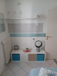 a room with a bed and a table with a mortar at Maison Prestige in Monfalcone +11 photos