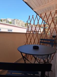 a table on a balcony with a view at Rooms Home in Palmi