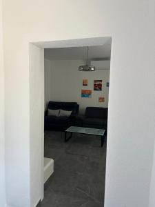 a living room with a couch and a table at Apartment Oblak in Vrsi +8 photos