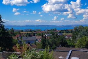 a city with a view of the water at Seeblick in Daisendorf +2 photos