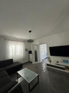 a living room with a couch and a coffee table at Apartment Oblak in Vrsi