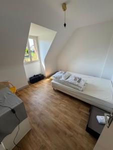 a bedroom with a bed in an attic at Maison trois chambres en impasse in Saint-Martin-des-Champs