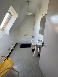 an attic bathroom with a sink and a bath tub at Maison trois chambres en impasse in Saint-Martin-des-Champs
