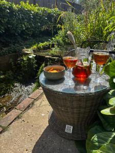 a table with three glasses of wine on it at Little Brook Retreat in Chelmsford