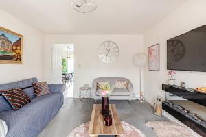 a living room with a blue couch and a table at Town house Anfield stadium in Liverpool