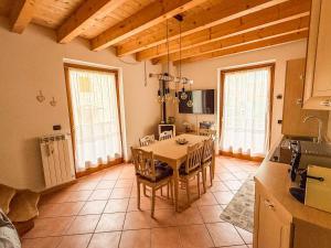 a kitchen with a table and chairs in a room at Alloggio Stella Alpina in Sondalo