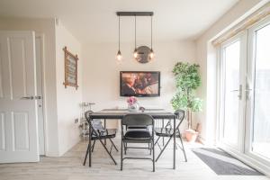 a dining room with a table and chairs at Town house Anfield stadium in Liverpool