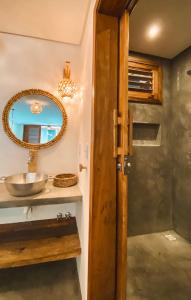 a bathroom with a sink and a mirror at Villa Beleza Prea Beachfront private room in Prea