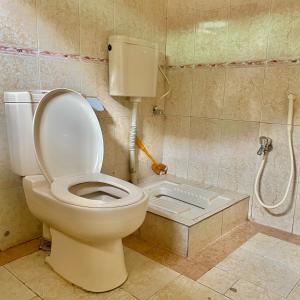 a bathroom with a toilet with the lid up at Dream Palace Naran in Naran +21 photos