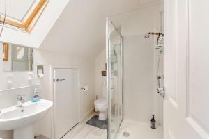 a bathroom with a shower and a toilet and a sink at Town house Anfield stadium in Liverpool +35 photos