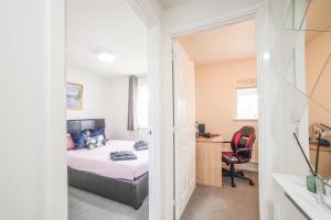 a bedroom with a bed and a desk and a chair at Town house Anfield stadium in Liverpool