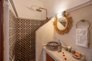 a bathroom with a sink and a mirror at Riad Jowara in Marrakech +18 photos