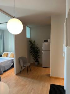 a bedroom with a bed and a chair and a refrigerator at Residenze Venezia Apartments in Mestre