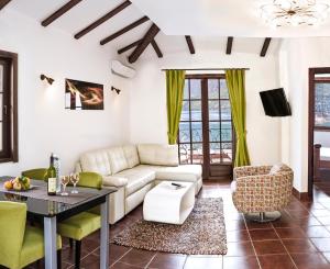 a living room with a couch and a table at Apartments Boka Vista in Kamenari