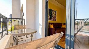 a balcony with a table and a couch at Harmony Apartment 2 in Bar