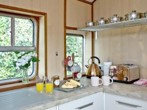 a kitchen with a counter top with orange juice and coffee cups at Brunel Boutique Railway Carriage 1 in Dawlish Warren